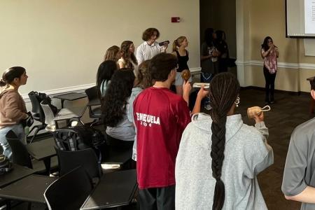 Students in a circle playing coco